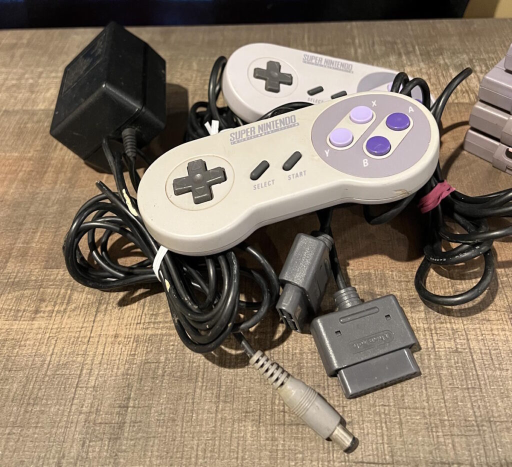 Original controllers and cords helps the value of a Super Nintendo