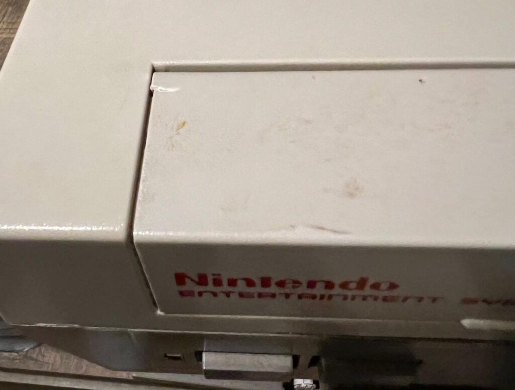 Nintendo NES with crack in cartridge lid